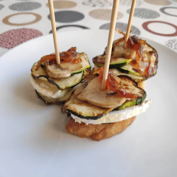 Pinchos de calabacín, queso rulo de cabra, champiñón y cebolla caramelizada