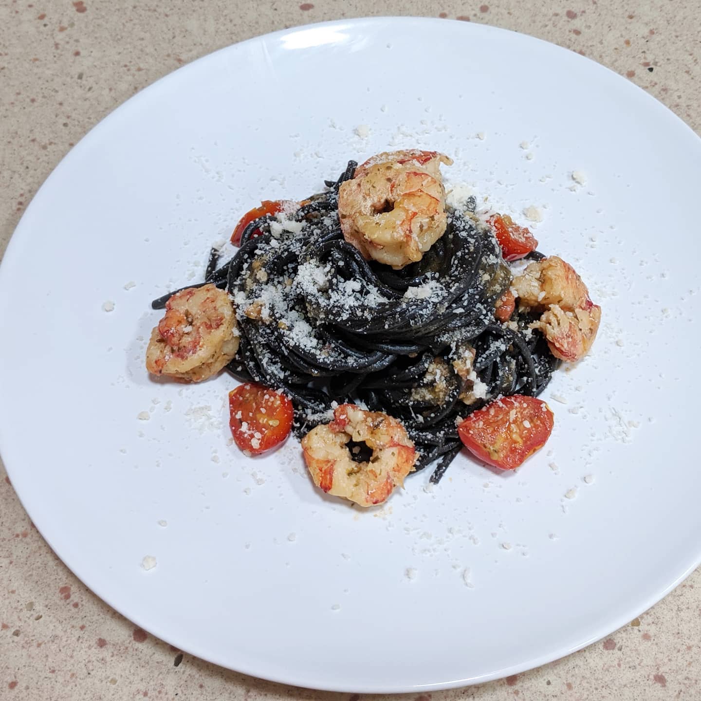 Spaghetti nero di seppia con gambón, cherrys y parmesano